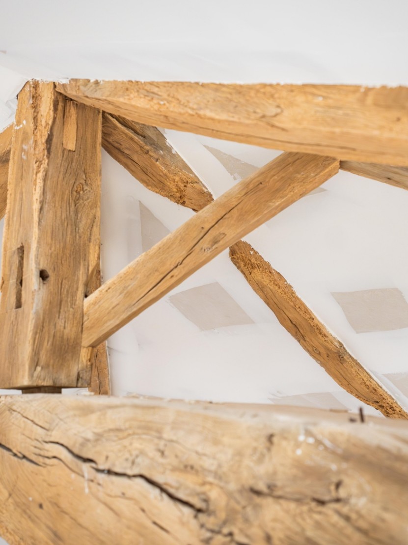 Poutres en bois dans un grenier rénové.